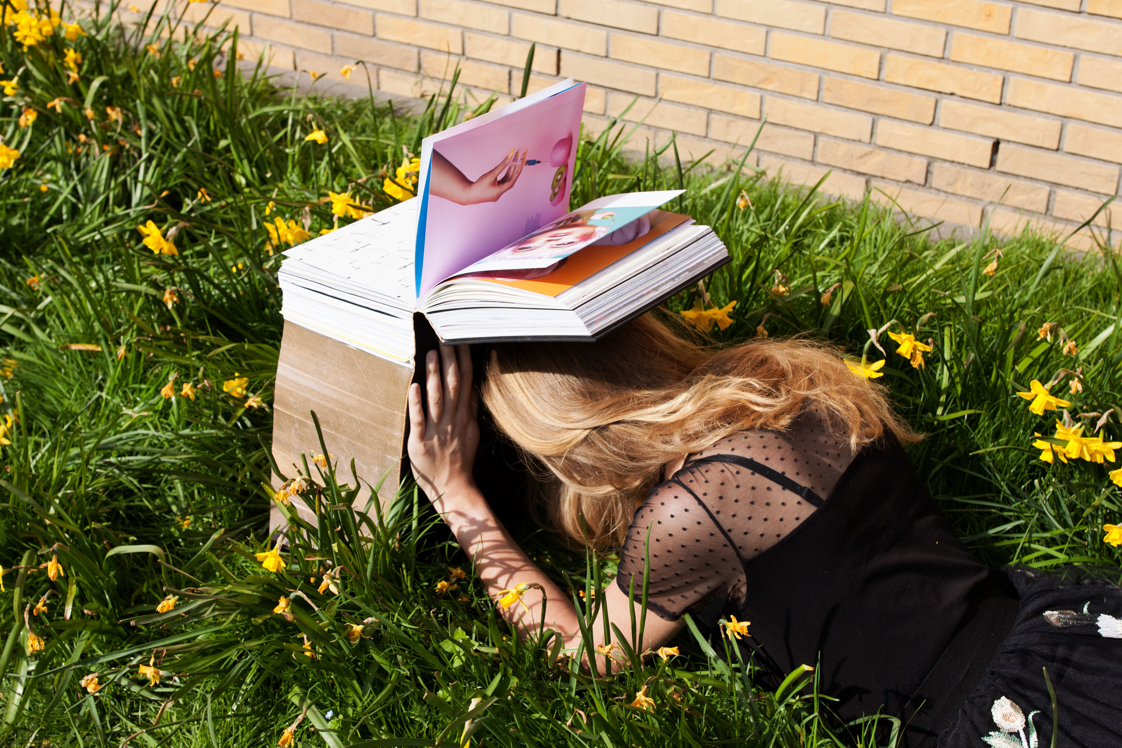 model with oen book over her head